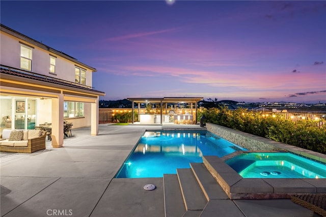 16671 Zest Ct, Riverside, CA 92503 - pool at dusk with a patio, a pool with connected hot tub, an outdoor hangout area, and a fenced backyard
