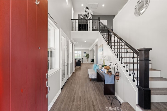 16671 Zest Ct, Riverside, CA 92503 - foyer entrance with stairs, a chandelier, wood finished floors, a high ceiling, and recessed lighting