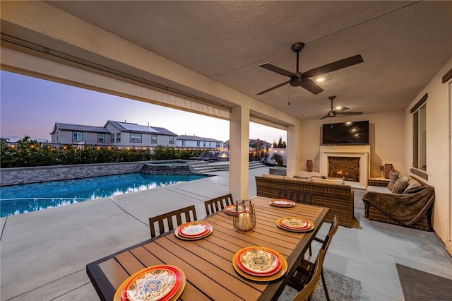 16671 Zest Ct, Riverside, CA 92503 - view of patio / terrace featuring a lit fireplace, a pool with connected hot tub, ceiling fan, and outdoor dining space