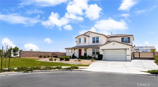 16671 Zest Ct, Riverside, CA 92503 - view of front facade with solar panels, driveway, a gate, stucco siding, and an attached garage
