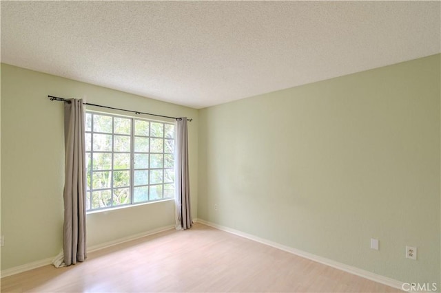 1430 Brett Pl Unit 12, San Pedro, CA 90732 - spare room with light wood finished floors and a textured ceiling