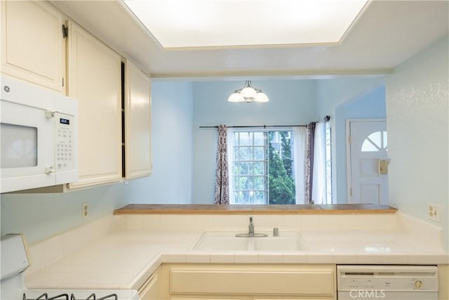 1430 Brett Pl Unit 12, San Pedro, CA 90732 - kitchen with white appliances, tile counters, and a chandelier