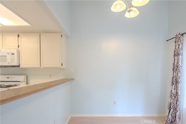 1430 Brett Pl Unit 12, San Pedro, CA 90732 - unfurnished dining area with a chandelier and baseboards