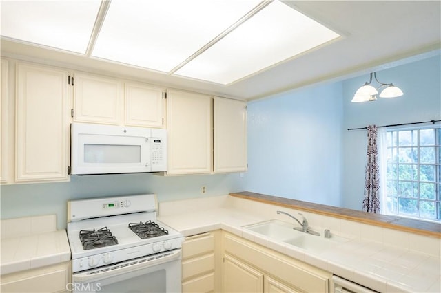 1430 Brett Pl Unit 12, San Pedro, CA 90732 - kitchen with white appliances, tile counters, and a peninsula
