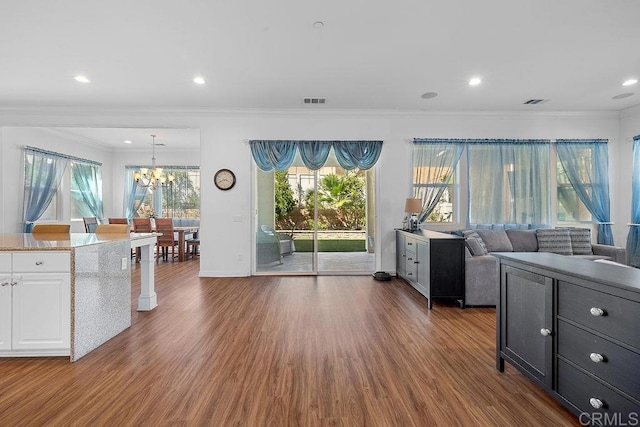 1837 Ashley Ave, Chula Vista, CA 91913 - kitchen featuring ornamental molding, a chandelier, wood finished floors, white cabinets, and plenty of natural light