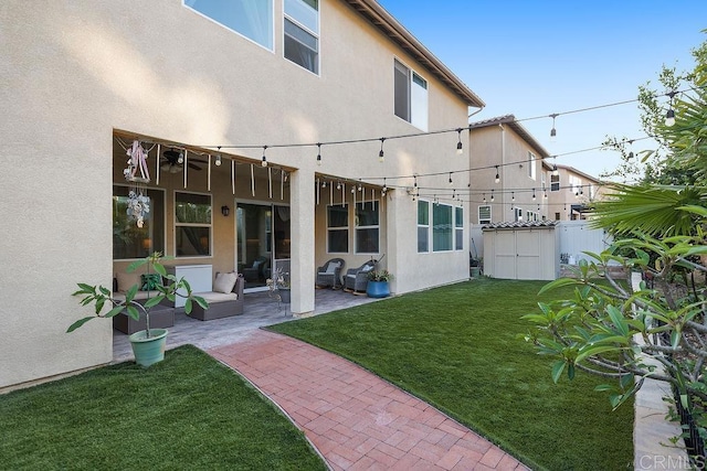 1837 Ashley Ave, Chula Vista, CA 91913 - rear view of property with a yard, a patio area, stucco siding, and a storage shed