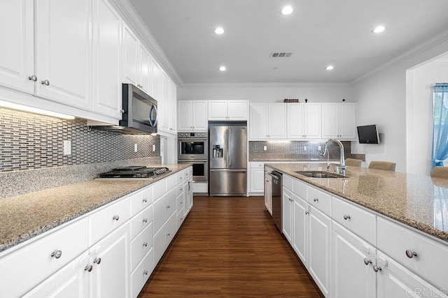 1837 Ashley Ave, Chula Vista, CA 91913 - kitchen with appliances with stainless steel finishes, decorative backsplash, white cabinetry, light stone countertops, and crown molding