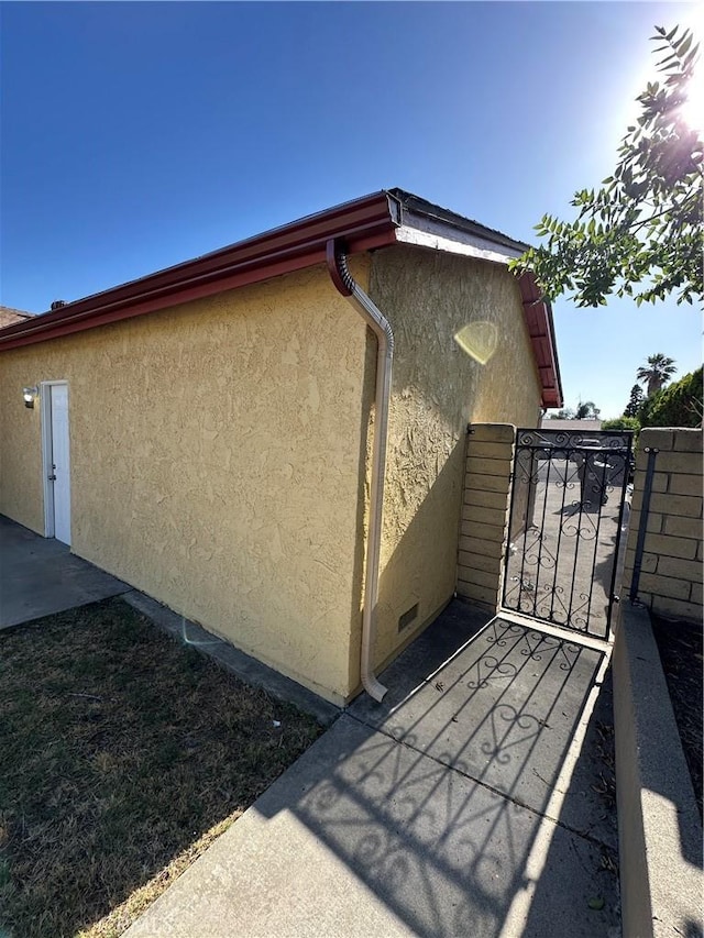 8567 Jasper St, Rancho Cucamonga, CA 91730 - view of home's exterior with stucco siding and a gate