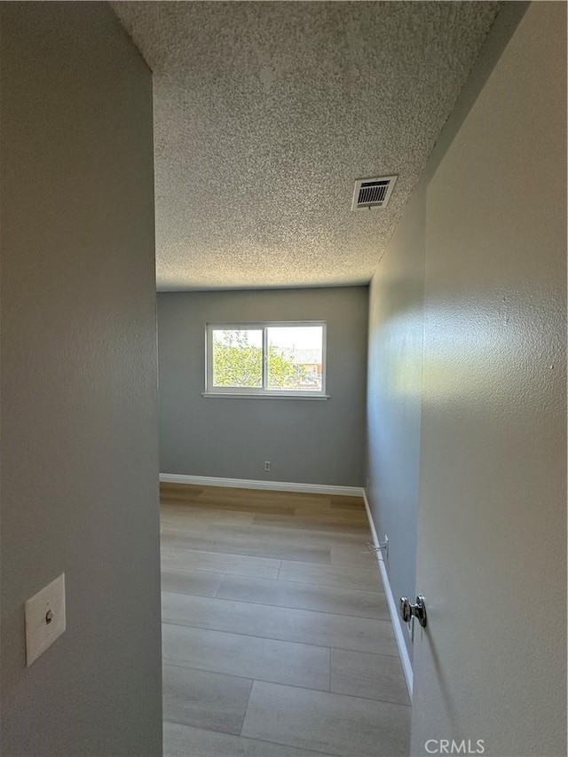 8567 Jasper St, Rancho Cucamonga, CA 91730 - empty room featuring a textured ceiling and wood finished floors