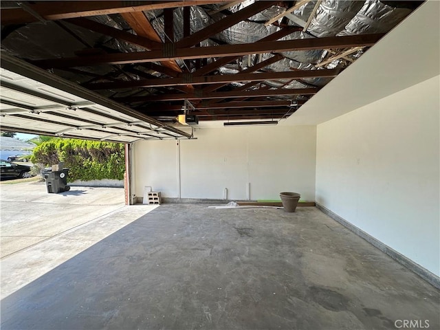 8567 Jasper St, Rancho Cucamonga, CA 91730 - garage with a garage door opener and baseboards