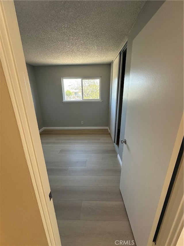 8567 Jasper St, Rancho Cucamonga, CA 91730 - spare room with light wood finished floors and a textured ceiling