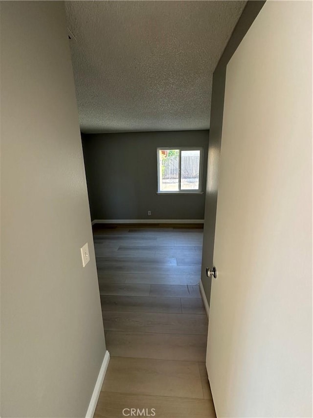 8567 Jasper St, Rancho Cucamonga, CA 91730 - hallway featuring a textured ceiling and wood finished floors