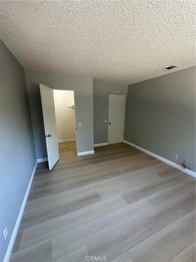 8567 Jasper St, Rancho Cucamonga, CA 91730 - empty room featuring a textured ceiling and light wood-style flooring