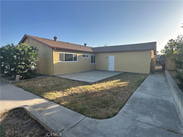 8567 Jasper St, Rancho Cucamonga, CA 91730 - rear view of house with a patio, stucco siding, and a gate