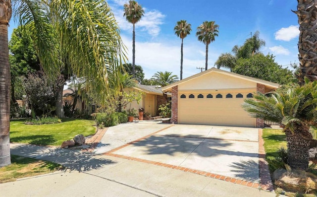 2045 W Clover Ave, Anaheim, CA 92801 - view of front of home with driveway, a front lawn, stucco siding, brick siding, and a garage