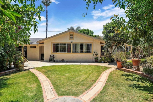 2045 W Clover Ave, Anaheim, CA 92801 - view of front of house with stucco siding, a front yard, and a patio area