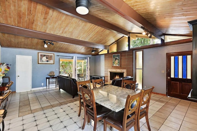 2045 W Clover Ave, Anaheim, CA 92801 - dining space with wood ceiling, light tile patterned floors, a warm lit fireplace, and track lighting