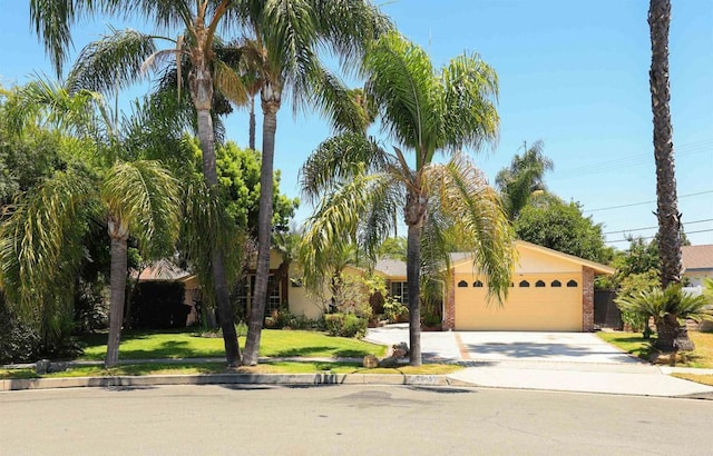 2045 W Clover Ave, Anaheim, CA 92801 - view of front facade with driveway, an attached garage, and a front yard