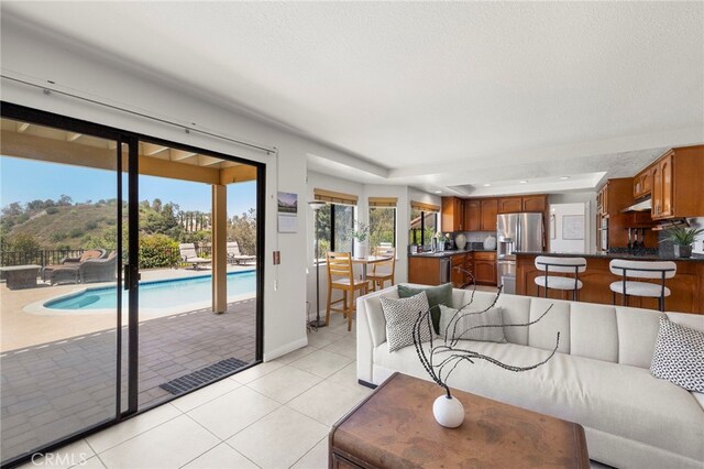 22074 Cedardale Dr, Diamond Bar, CA 91765 - living area featuring light tile patterned floors and baseboards