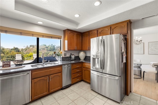 22074 Cedardale Dr, Diamond Bar, CA 91765 - kitchen featuring appliances with stainless steel finishes, brown cabinetry, a tray ceiling, recessed lighting, and light tile patterned floors