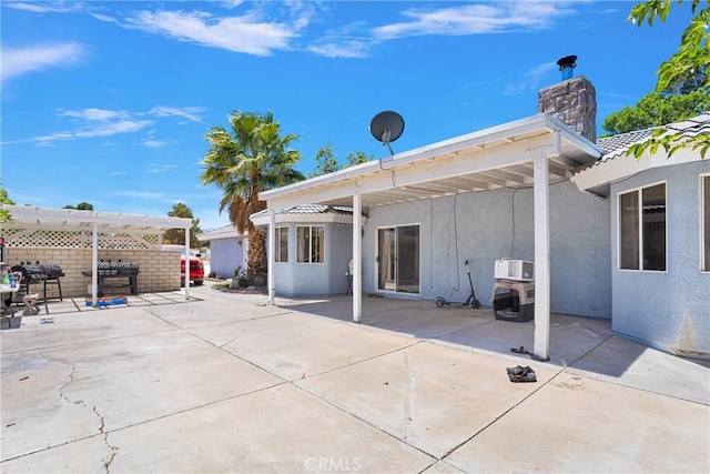 10325 Sheep Creek Rd, Phelan, CA 92371 - rear view of house with stucco siding, a patio, a pergola, and a chimney