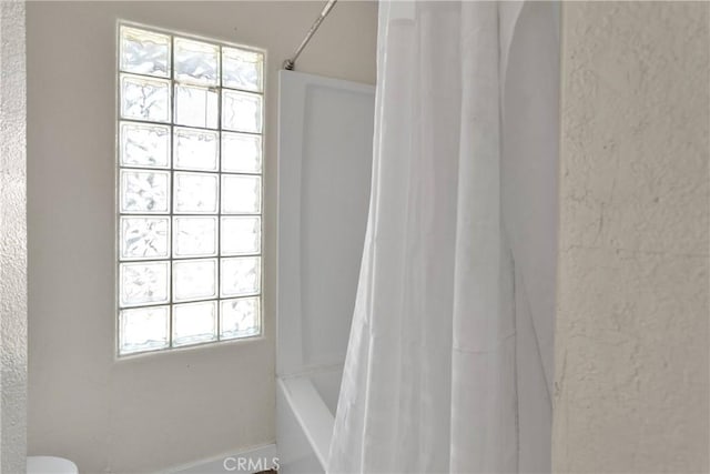 10325 Sheep Creek Rd, Phelan, CA 92371 - bathroom featuring plenty of natural light and shower / tub combo with curtain
