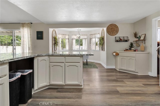 10325 Sheep Creek Rd, Phelan, CA 92371 - kitchen featuring dark wood-style flooring, white cabinetry, light stone counters, and a chandelier