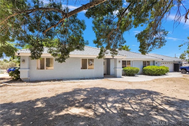10325 Sheep Creek Rd, Phelan, CA 92371 - ranch-style house with a tile roof, stucco siding, and an attached garage