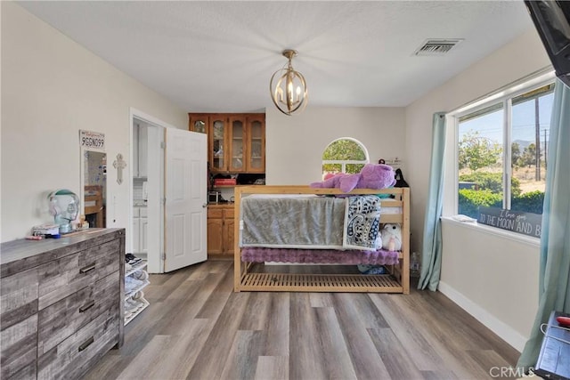 10325 Sheep Creek Rd, Phelan, CA 92371 - bedroom with wood finished floors and a chandelier