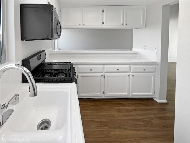 1815 W 145th St Unit 9, Gardena, CA 90249 - kitchen with stainless steel range with gas stovetop, white cabinets, and dark wood finished floors