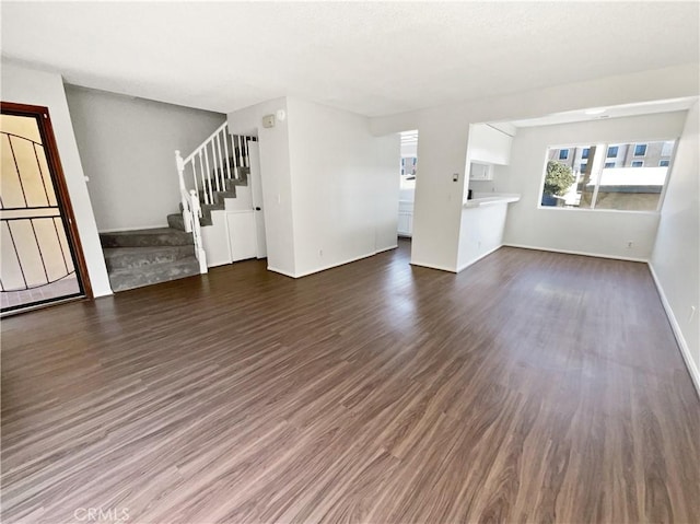 1815 W 145th St Unit 9, Gardena, CA 90249 - unfurnished living room featuring stairs and dark wood-type flooring