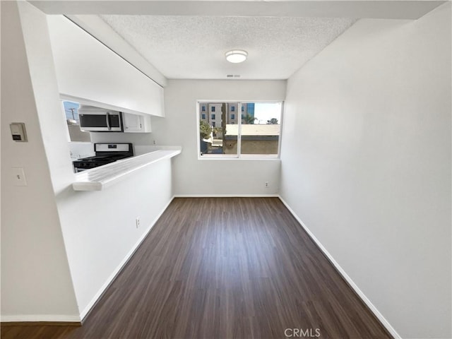 1815 W 145th St Unit 9, Gardena, CA 90249 - unfurnished dining area featuring a textured ceiling and dark wood-style floors