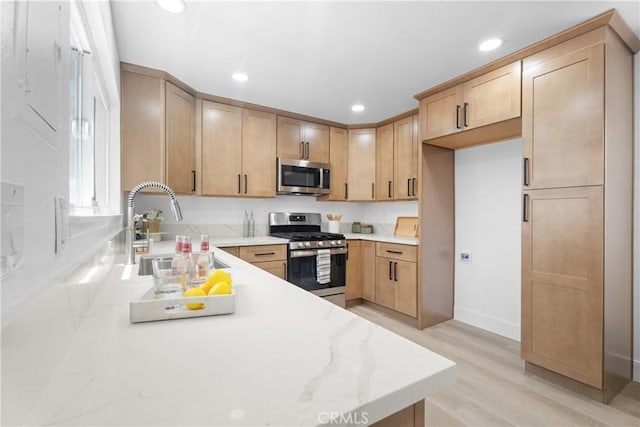 9554 Bickley Dr Unit 8, Huntington Beach, CA 92646 - kitchen featuring appliances with stainless steel finishes, recessed lighting, light wood-style floors, and light stone counters