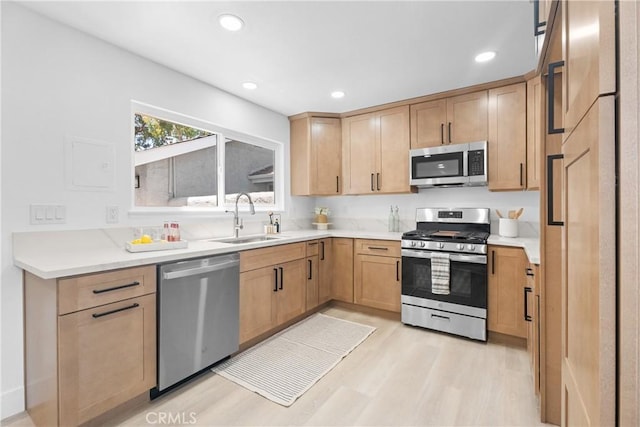 9554 Bickley Dr Unit 8, Huntington Beach, CA 92646 - kitchen with stainless steel appliances, light wood finished floors, light countertops, recessed lighting, and light brown cabinets