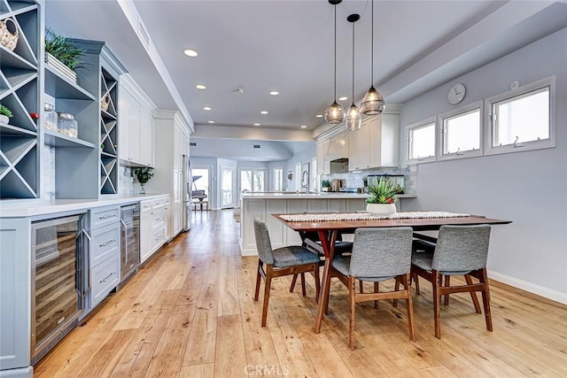 1310 Gates Ave, Manhattan Beach, CA 90266 - dining space with beverage cooler, light wood-style floors, a dry bar, and recessed lighting