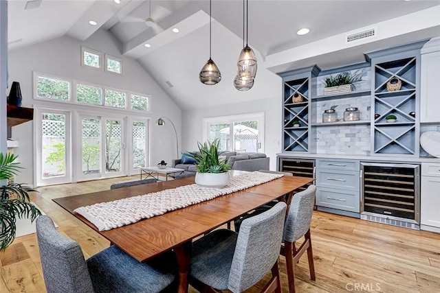 1310 Gates Ave, Manhattan Beach, CA 90266 - dining space with wine cooler, a dry bar, light wood-style flooring, recessed lighting, and high vaulted ceiling