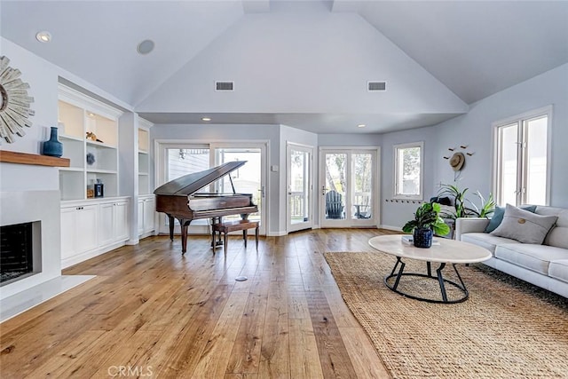 1310 Gates Ave, Manhattan Beach, CA 90266 - living room with light wood-style floors, high vaulted ceiling, built in features, and a fireplace with flush hearth