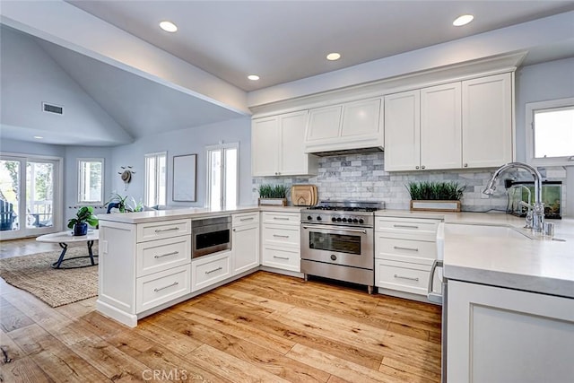1310 Gates Ave, Manhattan Beach, CA 90266 - kitchen with high end stove, a peninsula, healthy amount of natural light, lofted ceiling, and recessed lighting
