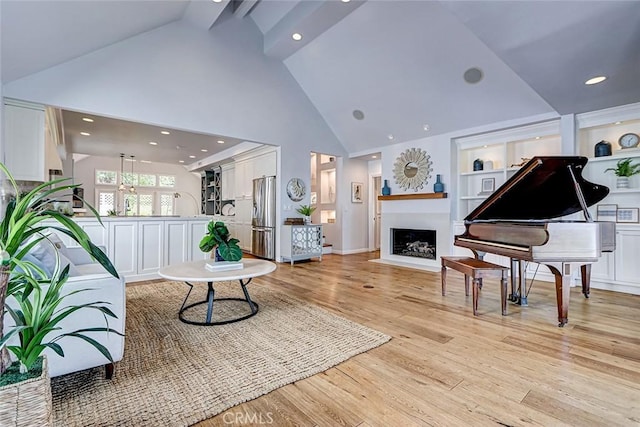 1310 Gates Ave, Manhattan Beach, CA 90266 - living room with high vaulted ceiling, a fireplace with flush hearth, light wood-style floors, recessed lighting, and built in features