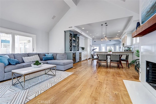 1310 Gates Ave, Manhattan Beach, CA 90266 - living room featuring light wood-type flooring, high vaulted ceiling, a fireplace with flush hearth, and recessed lighting