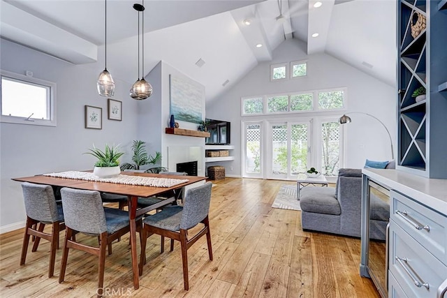 1310 Gates Ave, Manhattan Beach, CA 90266 - dining room featuring light wood-type flooring, a fireplace, high vaulted ceiling, recessed lighting, and beverage cooler