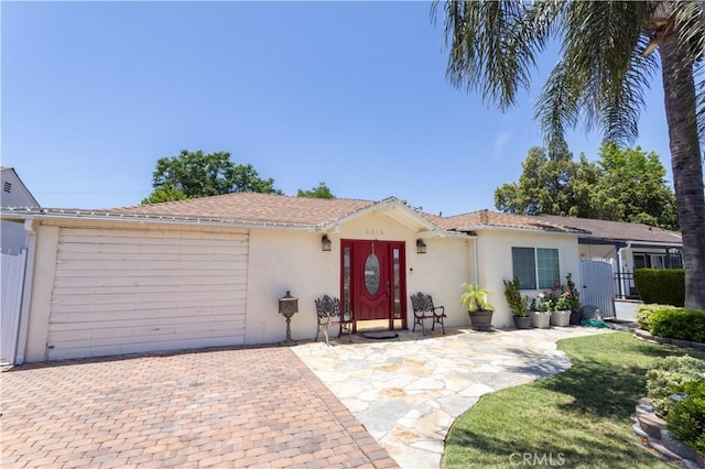 6843 Penfield Ave, Winnetka, CA 91306 - ranch-style house with stucco siding, driveway, an attached garage, and a gate