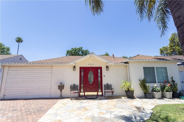 6843 Penfield Ave, Winnetka, CA 91306 - ranch-style house featuring stucco siding, an attached garage, and decorative driveway