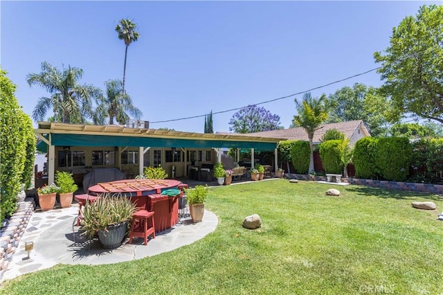 6843 Penfield Ave, Winnetka, CA 91306 - back of house featuring a patio area and a lawn