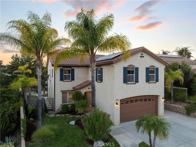 28238 Alton Way, Castaic, CA 91384 - mediterranean / spanish-style house featuring concrete driveway, roof mounted solar panels, stucco siding, and a garage