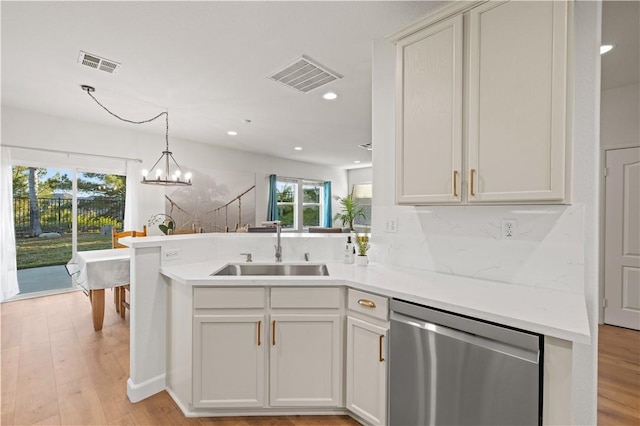 28238 Alton Way, Castaic, CA 91384 - kitchen with stainless steel dishwasher, a peninsula, light countertops, a chandelier, and recessed lighting
