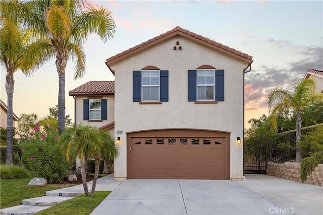 28238 Alton Way, Castaic, CA 91384 - mediterranean / spanish house featuring driveway, an attached garage, a tiled roof, and stucco siding