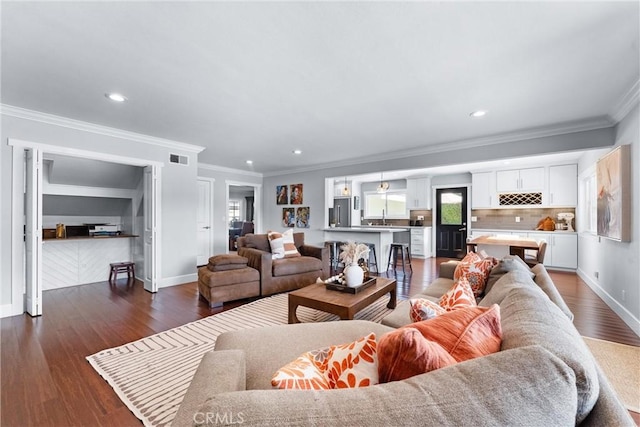 1780 N Mockingbird Pl, Orange, CA 92867 - living room featuring ornamental molding, dark wood-style flooring, and recessed lighting