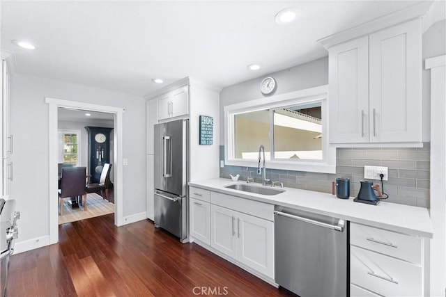 1780 N Mockingbird Pl, Orange, CA 92867 - kitchen with stainless steel appliances, tasteful backsplash, dark wood-style flooring, white cabinets, and recessed lighting
