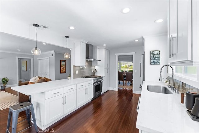 1780 N Mockingbird Pl, Orange, CA 92867 - kitchen featuring high end stove, wall chimney range hood, a peninsula, recessed lighting, and tasteful backsplash